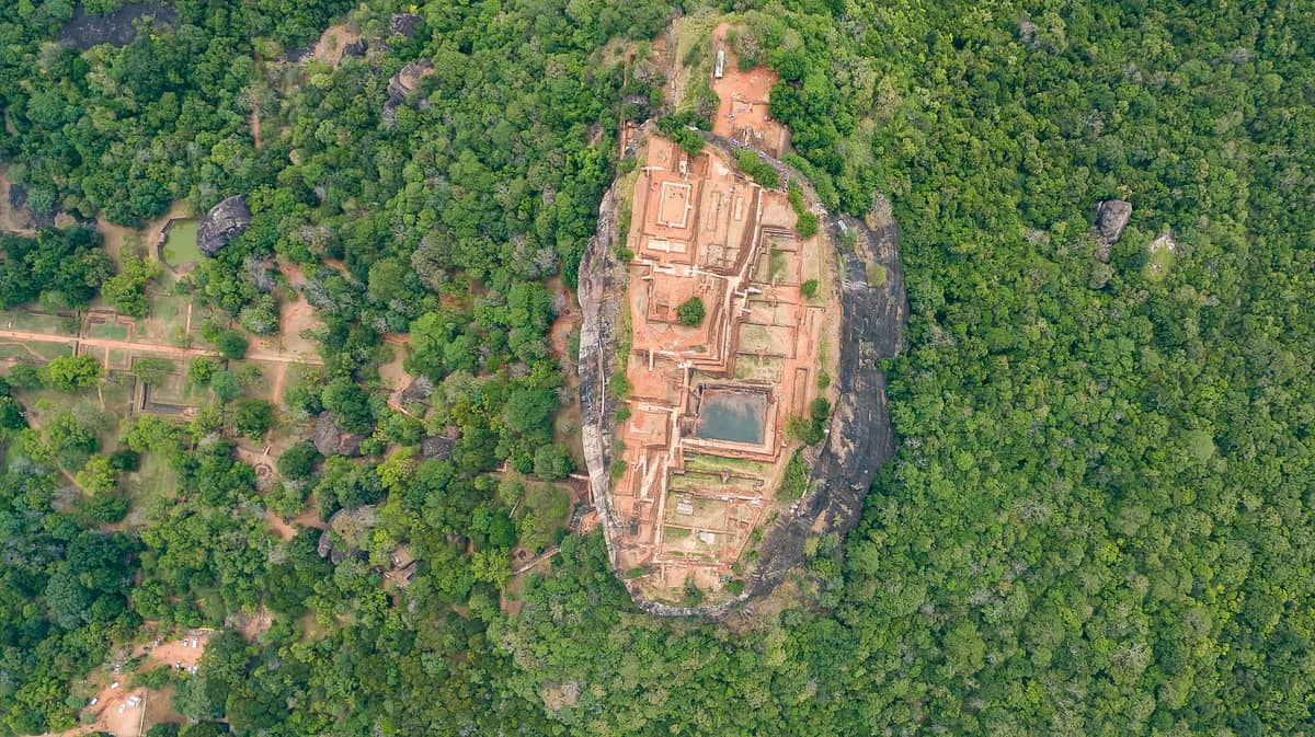 The castle lies in ruins on the steep slopes and on the summit of the granite peak.